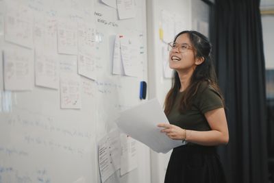 happy woman in front of a board